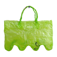 a green plastic bag with handles on a black background